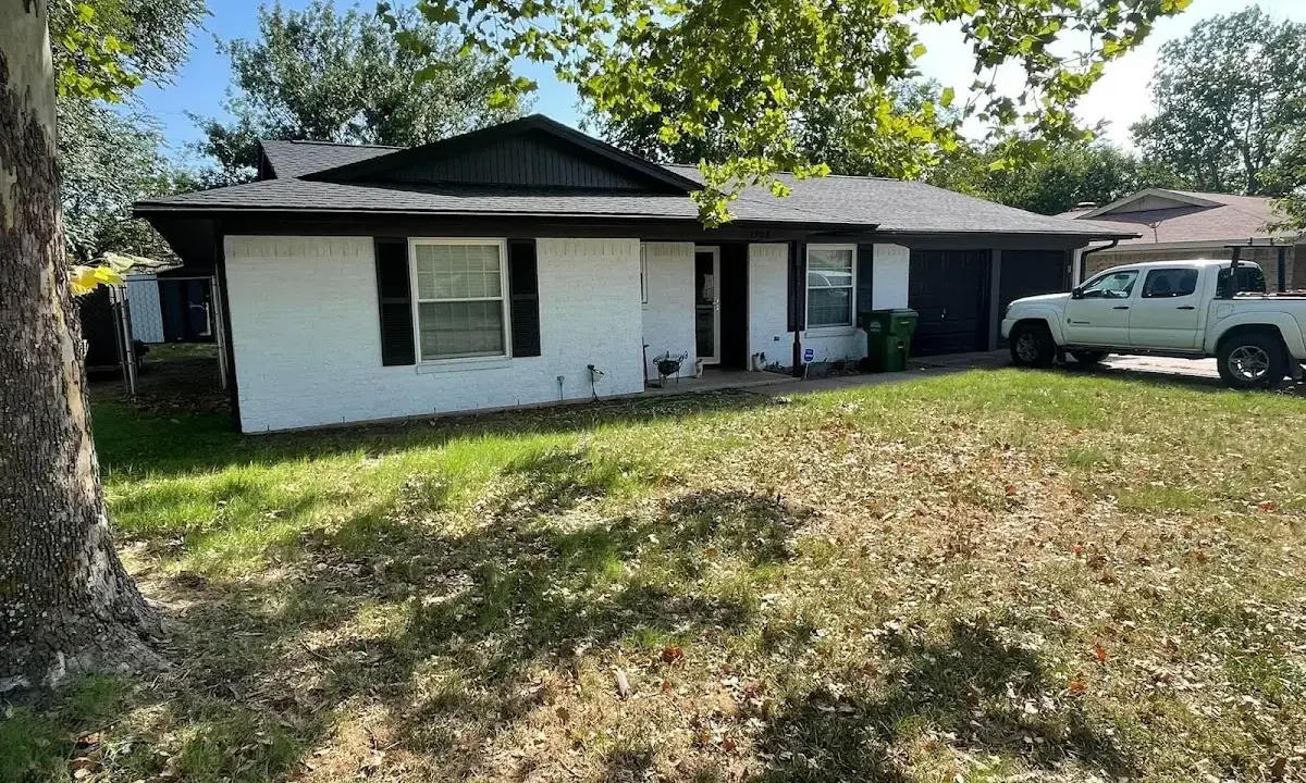 Professional roofing crew working on a residential roof in Wilton